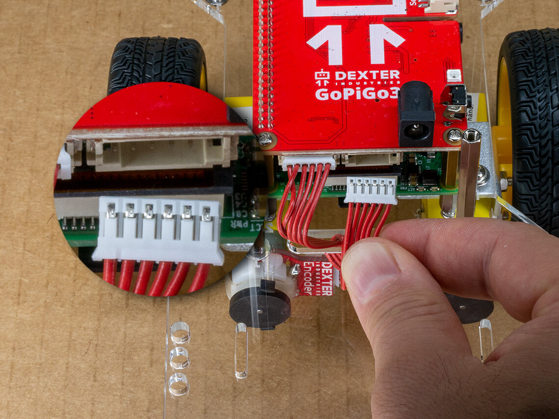 Connect the motor cables to the red electronic board- only one orientation will work.